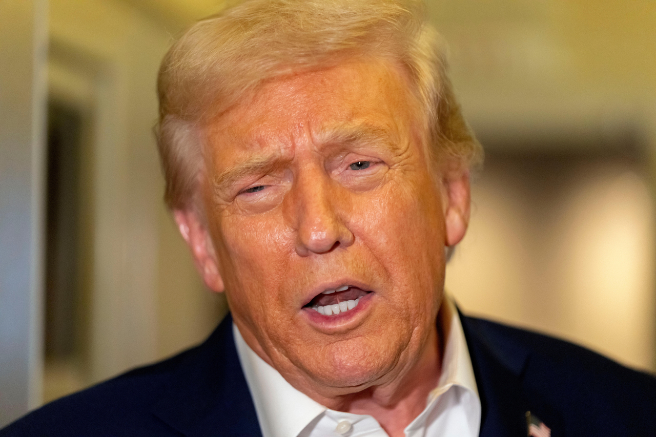 US President Donald Trump speaks to reporters aboard Air Force One en route to Asia on Friday. (AP-Yonhap)