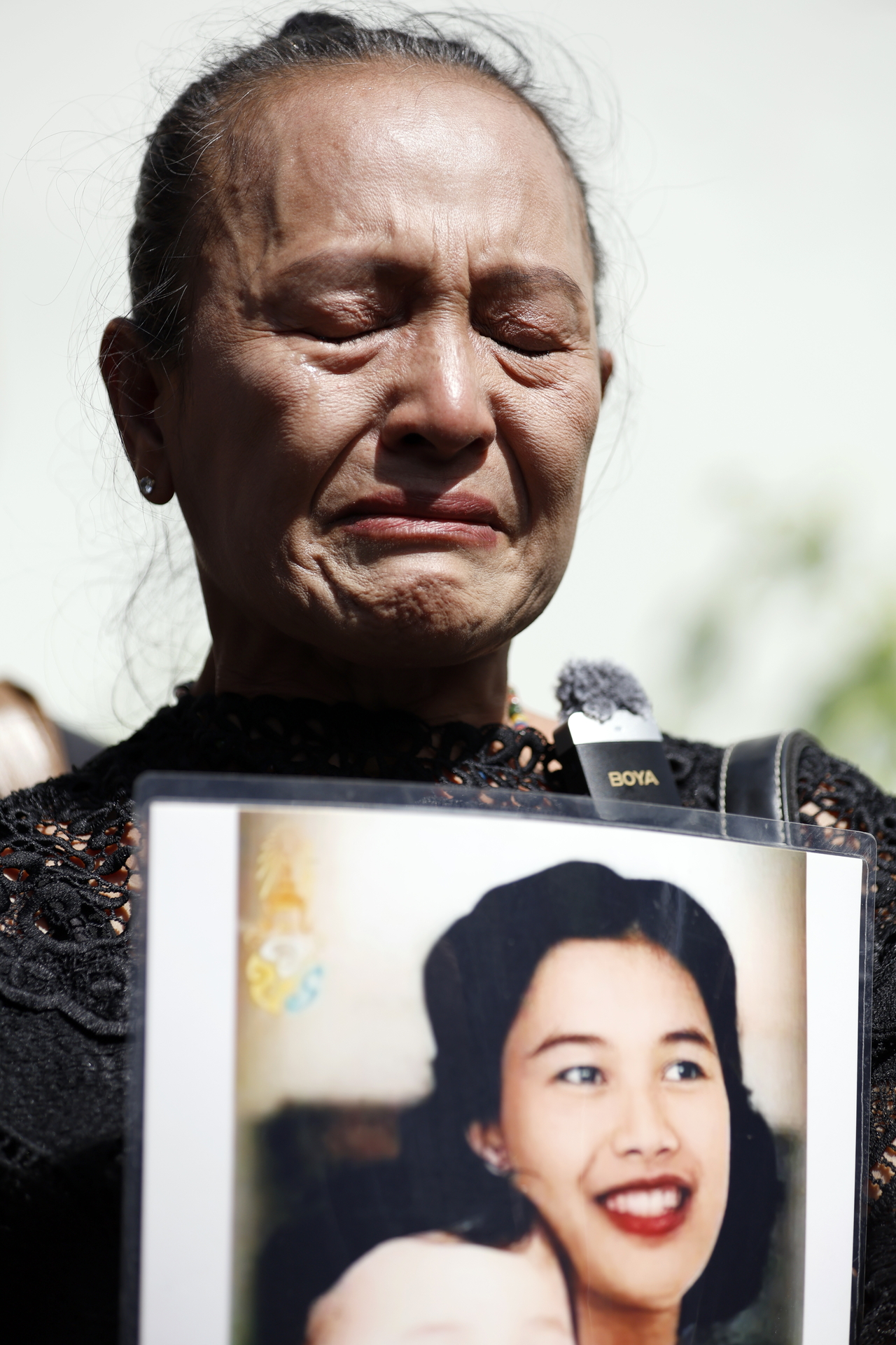 A mourning Thai woman holds a photograph of Queen Mother Sirikit, in Bangkok, Thailand, Saturday.   (EPA-Yonhap)