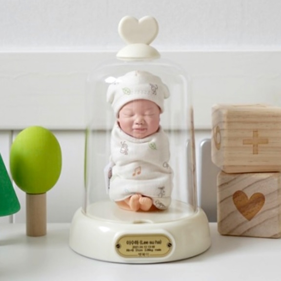 A tiny 3D-printed baby figurine used to preserve an umbilical cord. (Parkergavin)