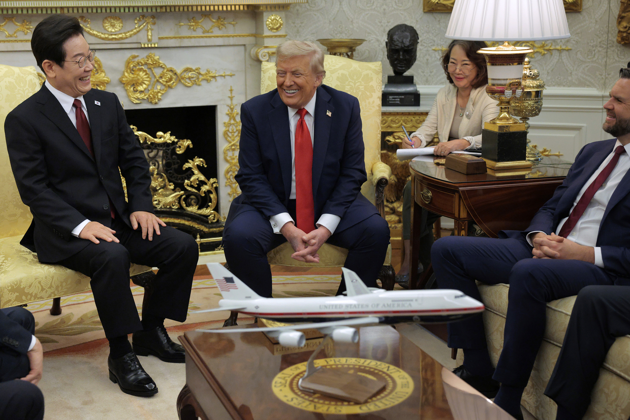South Korean President Lee Jae Myung and US President Donald Trump (center) share a laugh while talking to reporters before an Oval Office meeting with Vice President JD Vance at the White House on August 25, 2025 in Washington, DC. (Getty Images)