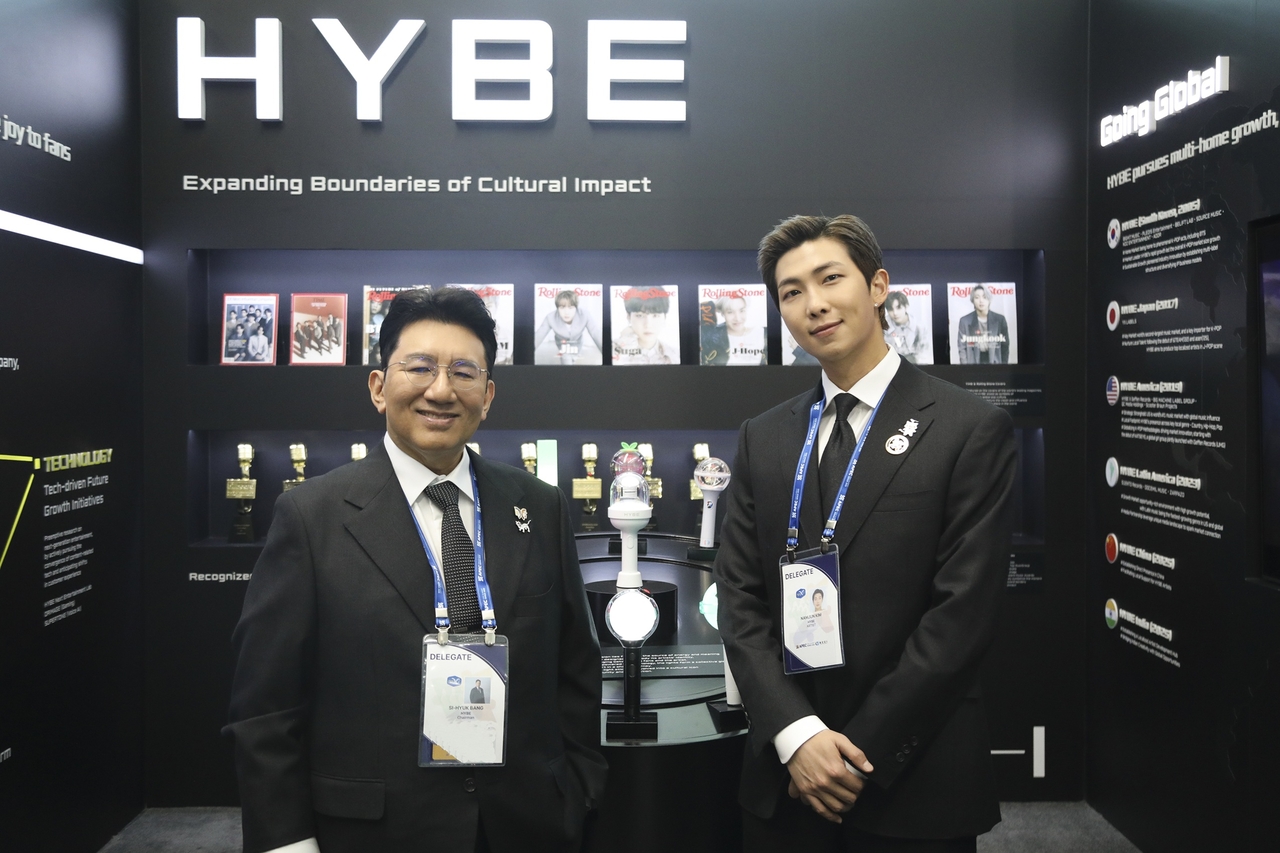 Hybe chairman Bang Si-hyuk and BTS member RM visit the Hybe booth during the opening ceremony of the APEC CEO Summit at Gyeongju Arts Center, North Gyeongsang Province, Wednesday. (Newsis)