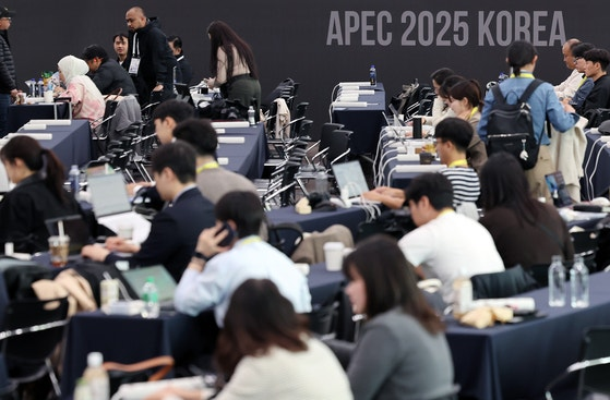 Reporters from around the world prepare for coverage at the International Media Center in Gyeongju’s Bomun Tourist Complex on Monday, marking the start of the 2025 APEC Summit week. (Yonhap)