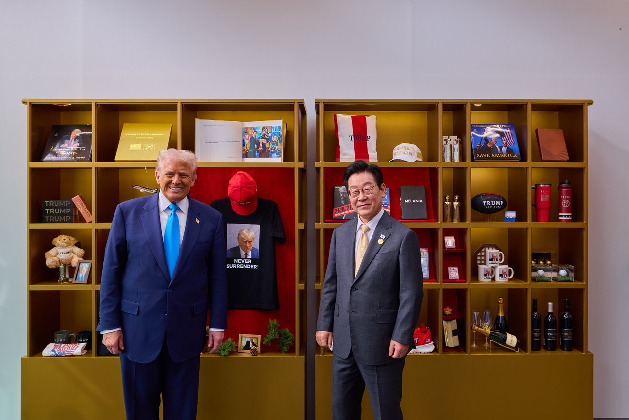 This file photo, provided by the Presidential Office, shows South Korean President Lee Jae-myung and US President Donald Trump taking a photo after viewing an exhibition of Trump-themed goods at the Gyeongju National Museum in North Gyeongsang Province, ahead of their summit talks on Wednesday. (Yonhap)