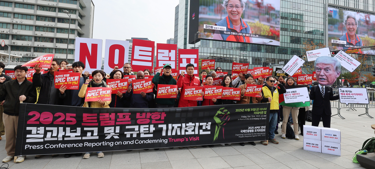 Activists from the organizing committee for the International People’s Response Against APEC 2025 take part in a protest condemning US President Donald Trump in front of the US Embassy in Jongno-gu, central Seoul, on Friday. (Yonhap)