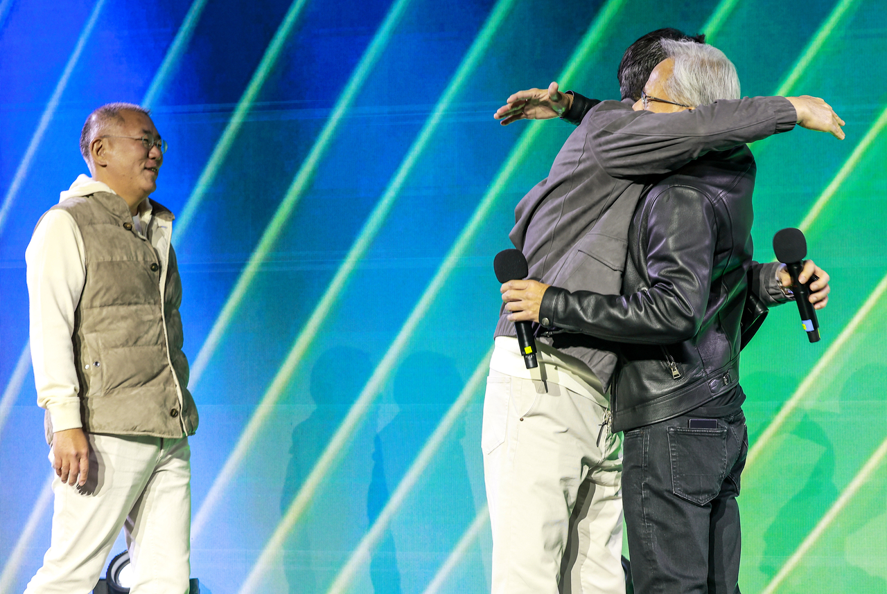 Nvidia CEO Jensen Huang (left) hugs Samsung Electronics Chairman Lee Jae-yong, while Hyundai Motor Group Executive Chair Chung Euisun (right) looks on, at Nvidia’s 25th-anniversary event for the launch of its GeForce graphics cards at Coex in Seoul on Thursday.  (Yonhap)