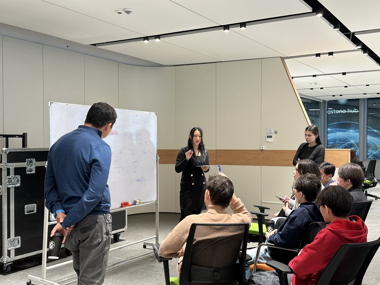 Students of Tomorrow School at Astana Hub gather around a whiteboard to discuss ideas and plans for their project. (Lee Jung-joo/The Korea Herald)