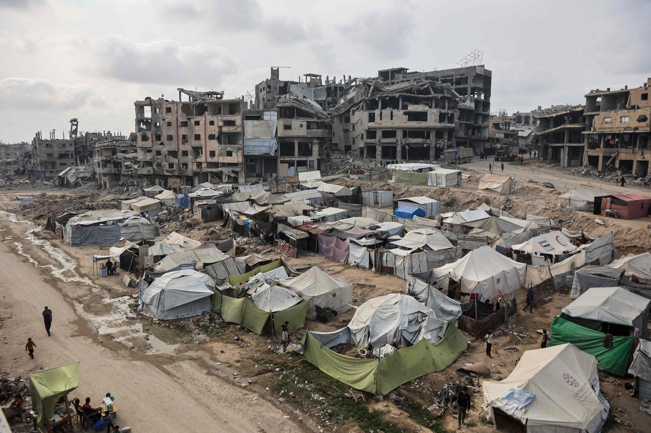 Palestinians walk around their tents in Gaza City on Monday. (AFP-Yonhap)