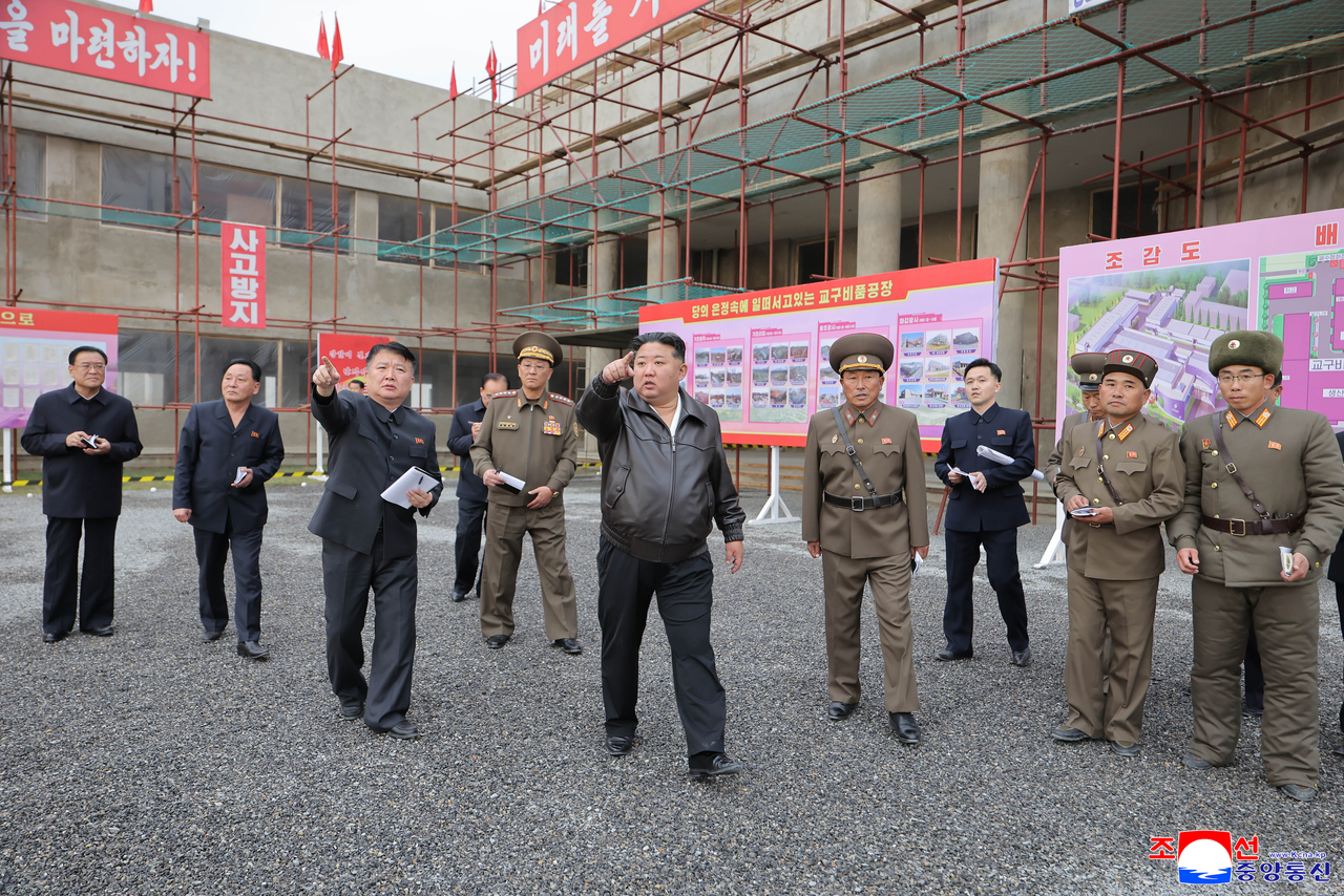 North Korean leader Kim Jong-un (C) visits school supply and teaching tool factories under construction on Tuesday. (KCNA via Yonhap)