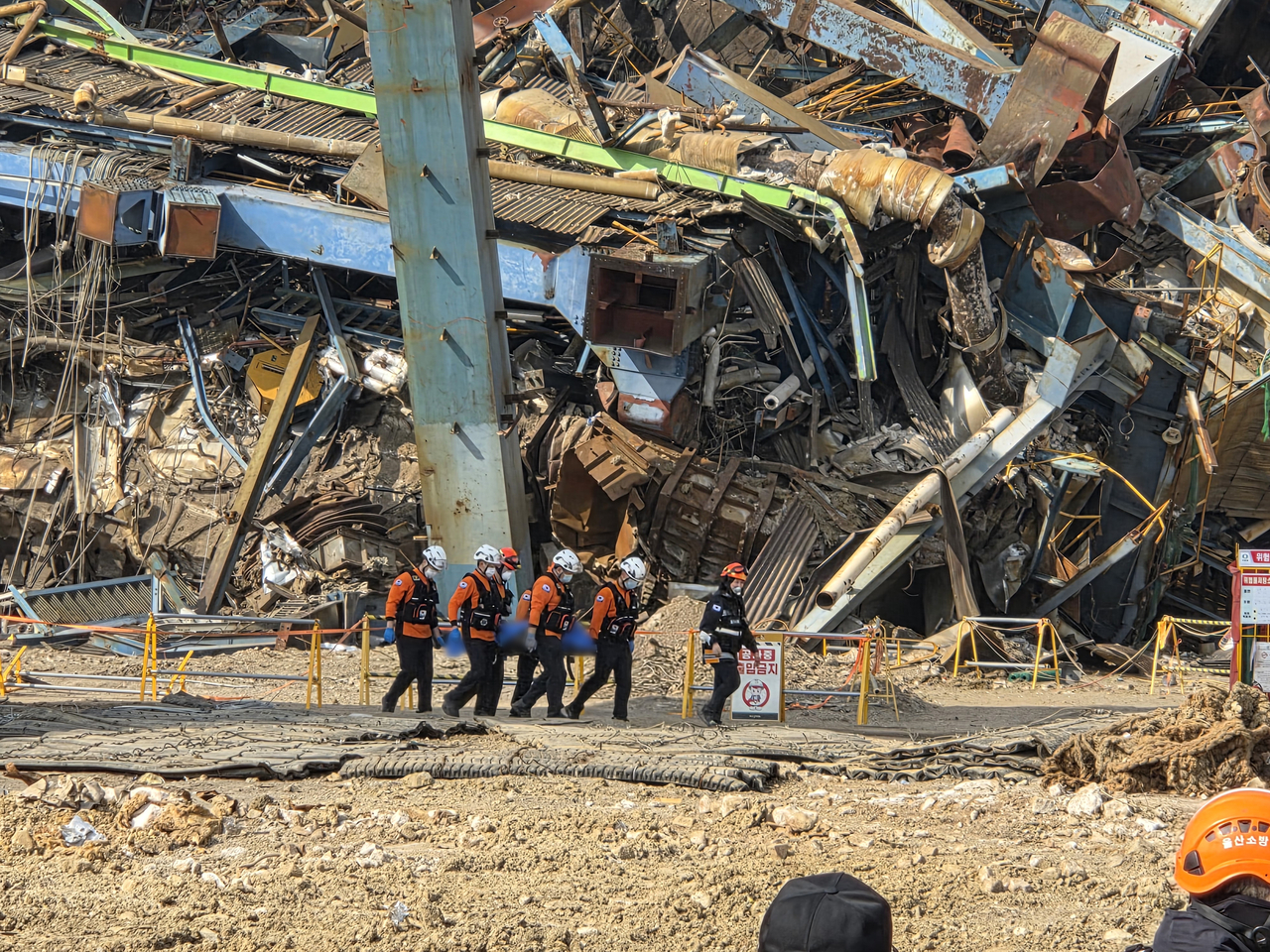 Emergency responders transport a worker found at the site of the incident on Friday. (Yonhap)