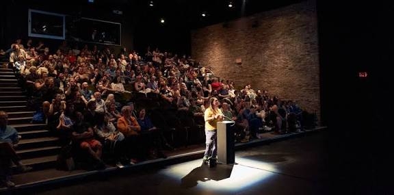 Audience watch as a controller plays a game during "asses.masses." (asses.masses official website)