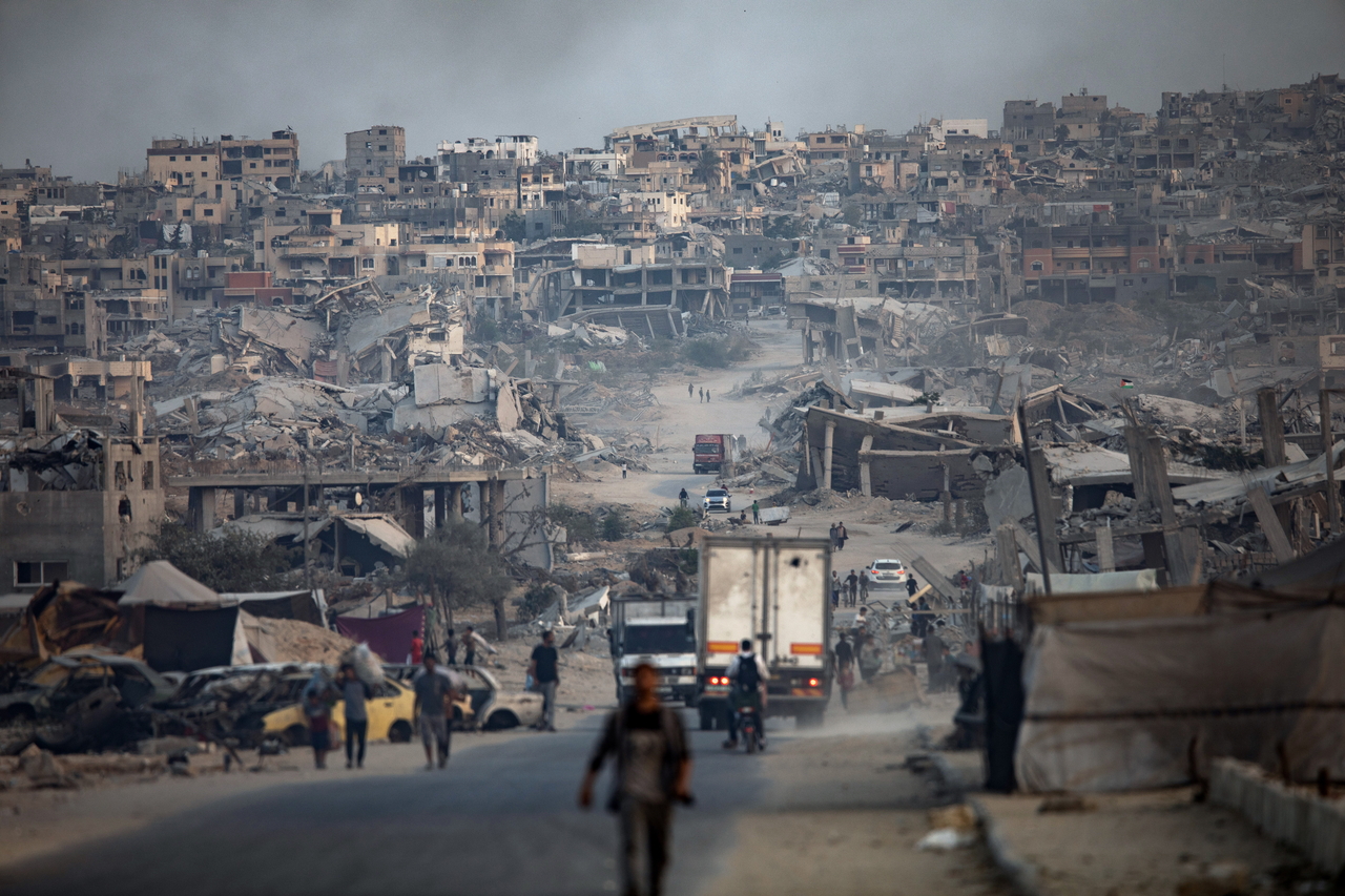 Displaced Palestinians walk among damaged buildings in Khan Younis, Gaza Strip, Saturday. (EPA-Yonhap)