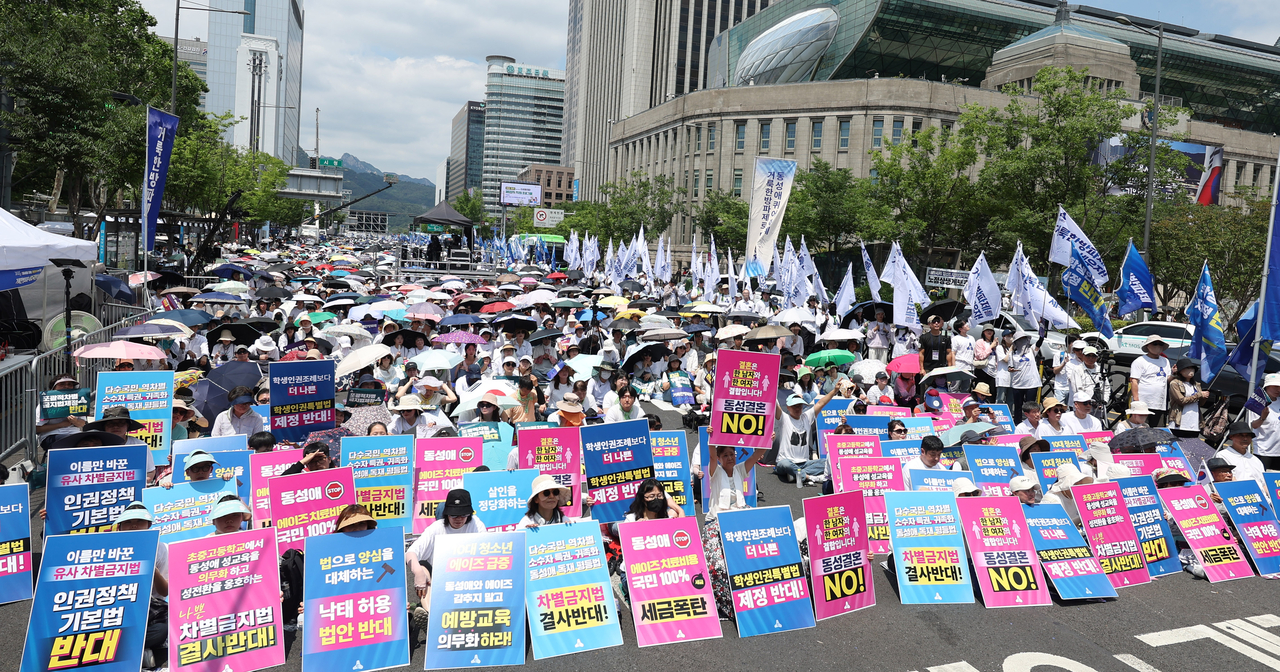 Protesters affiliated with a Christian civic group demonstrate against LGBTQ rights initiatives and anti-discrimination legislation during a rally near Seoul City Hall on June 14. (Newsis)