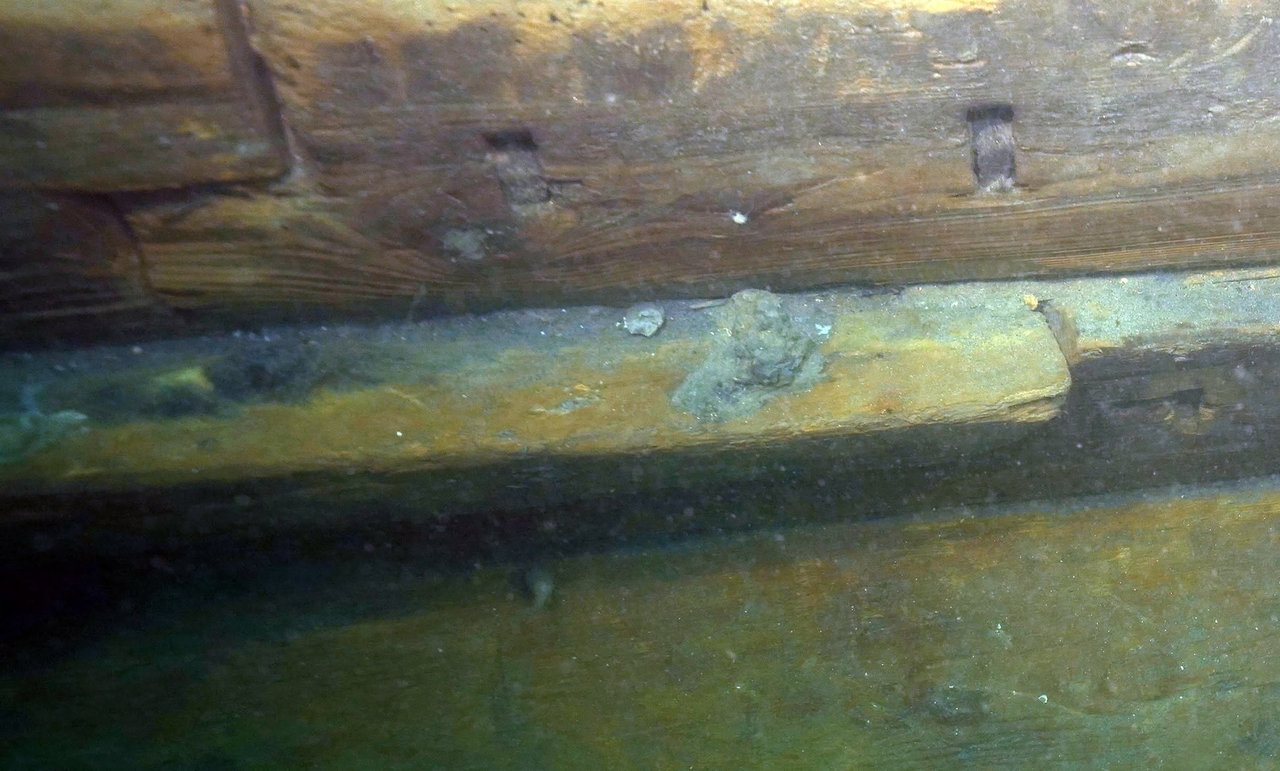 A close-up of Mado 4 shows traces of iron nails used in hull repairs, marking the first confirmed use of metal fasteners in a traditional Korean vessel. (Yonhap)