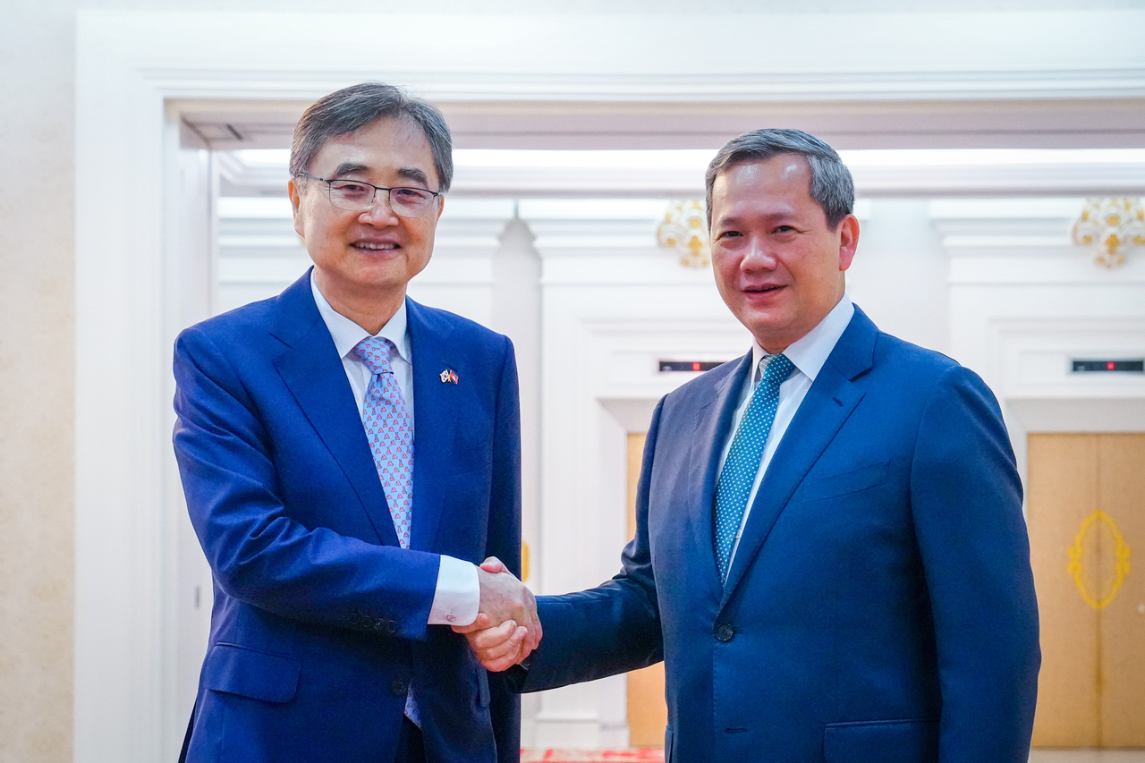 Foreign Minister Cho Hyun (left) shakes hands with Cambodian Prime Minister Hun Manet in Cambodia, on Monday. (Ministry of Foreign Affairs)