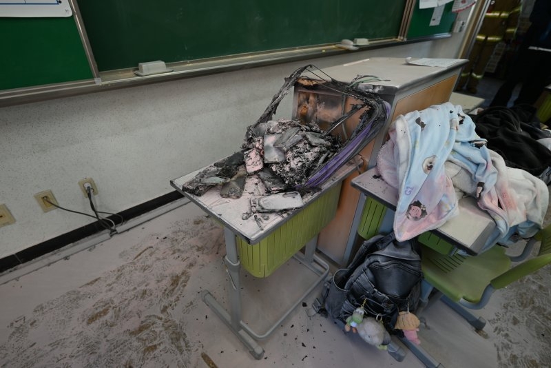 This photo, provided by the Gyeonggi-do Fire and Disaster Headquarters, shows a classroom damaged by a fire that broke out inside a locker containing mobile phones and a charger.