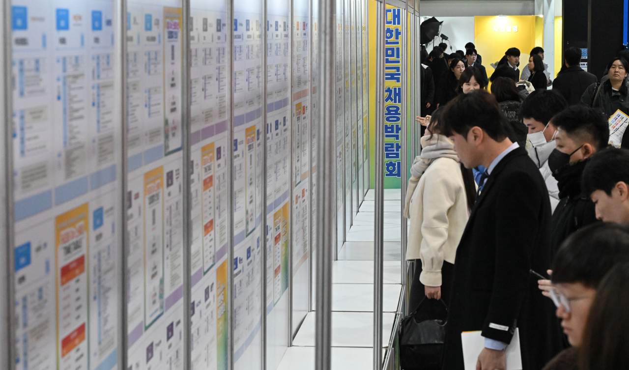Job seekers look over job postings at the 2025 Korea Job Fair held at the aT Center in Seocho-gu, southern Seoul, on the morning of March 19. (Im Se-jun / The Korea Herald)