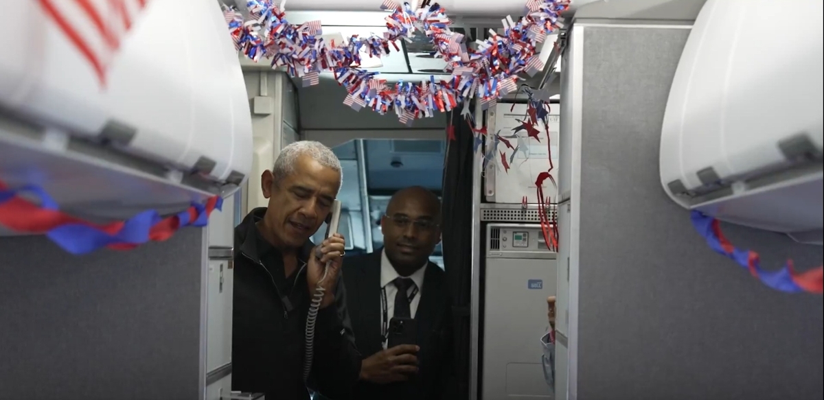 Former US President Barack Obama speaks via intercom on a flight to honor Korean War and Vietnam War veterans ahead of Veterans Day, in this photo captured Tuesday, from his X account. (Yonhap)