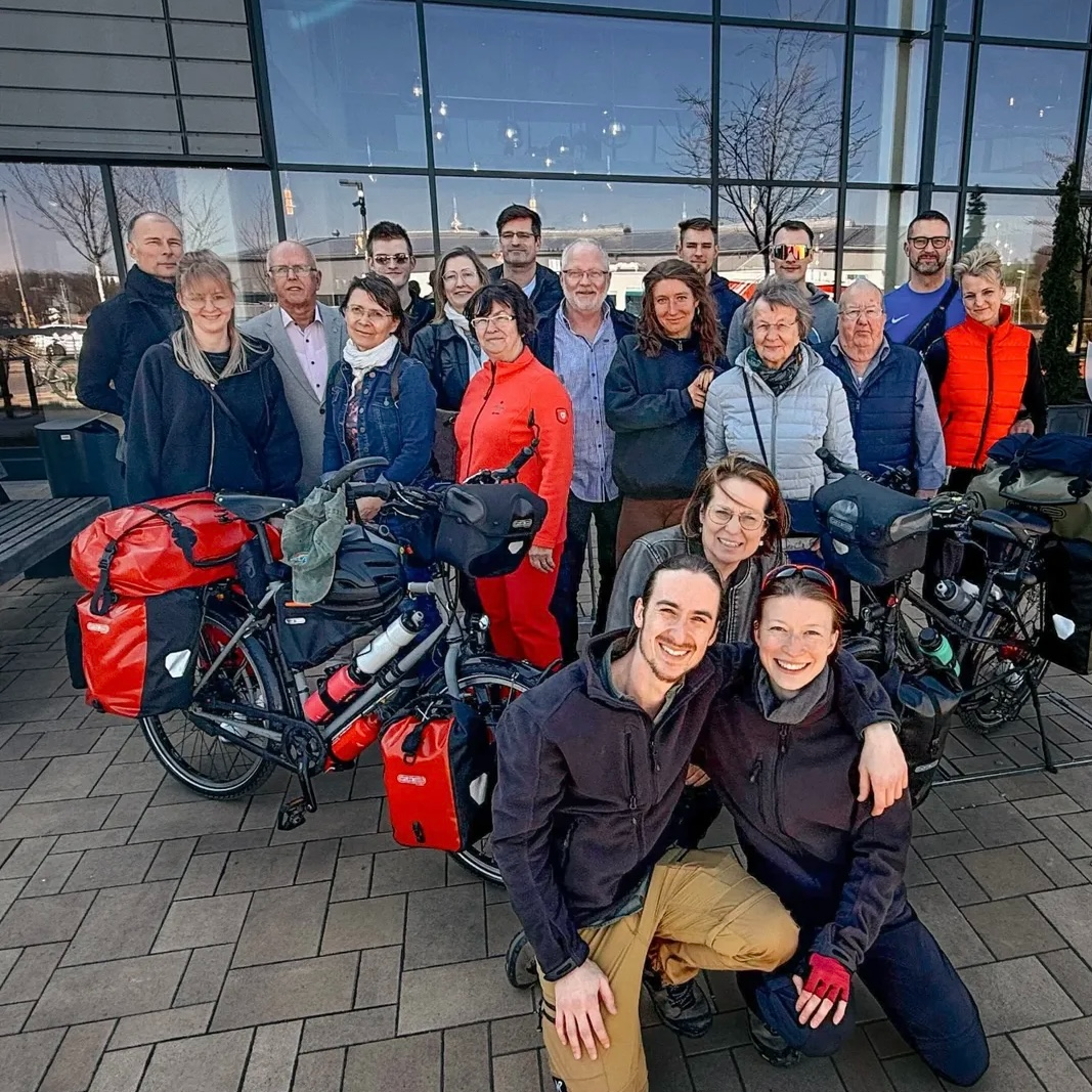Philipp Springsguth (front left) and Maria West (front right) pose for a photo with family and friends in Germany in March, before they set out on their bike world tour.  (Springsguth and West)