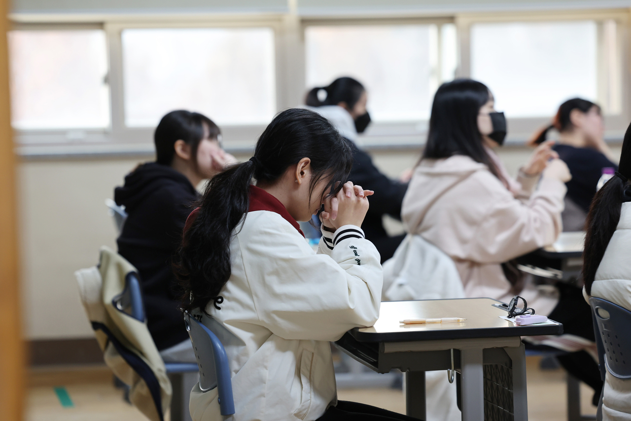 Students wait to begin the 2026 College Scholastic Ability Test at Inhwa Girls’ High School in Michuhol-gu, Incheon, on Thursday morning. (Yonhap)