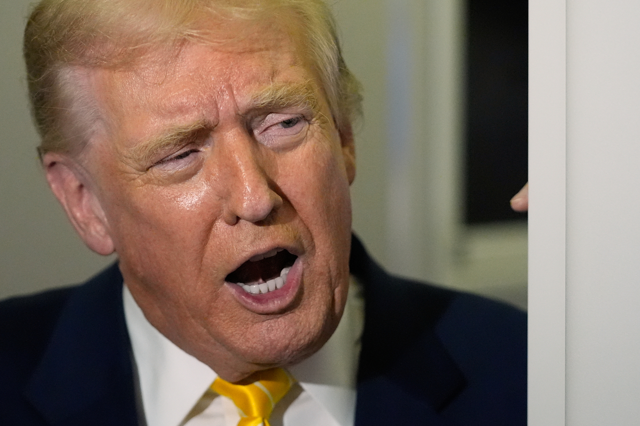 US President Donald Trump speaks to reporters on Air Force One on his way to his Mar-a-Lago estate in Palm Beach, Fla., Friday. (AP-Yonhap)