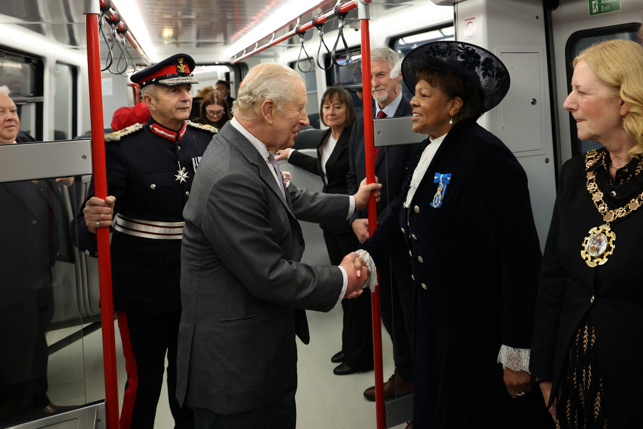 Britain's King Charles III (center) meets with people as he travels on a Stadler Class 398 Tram during a visit to South Wales, Friday.   (Reuters-Yonhap)
