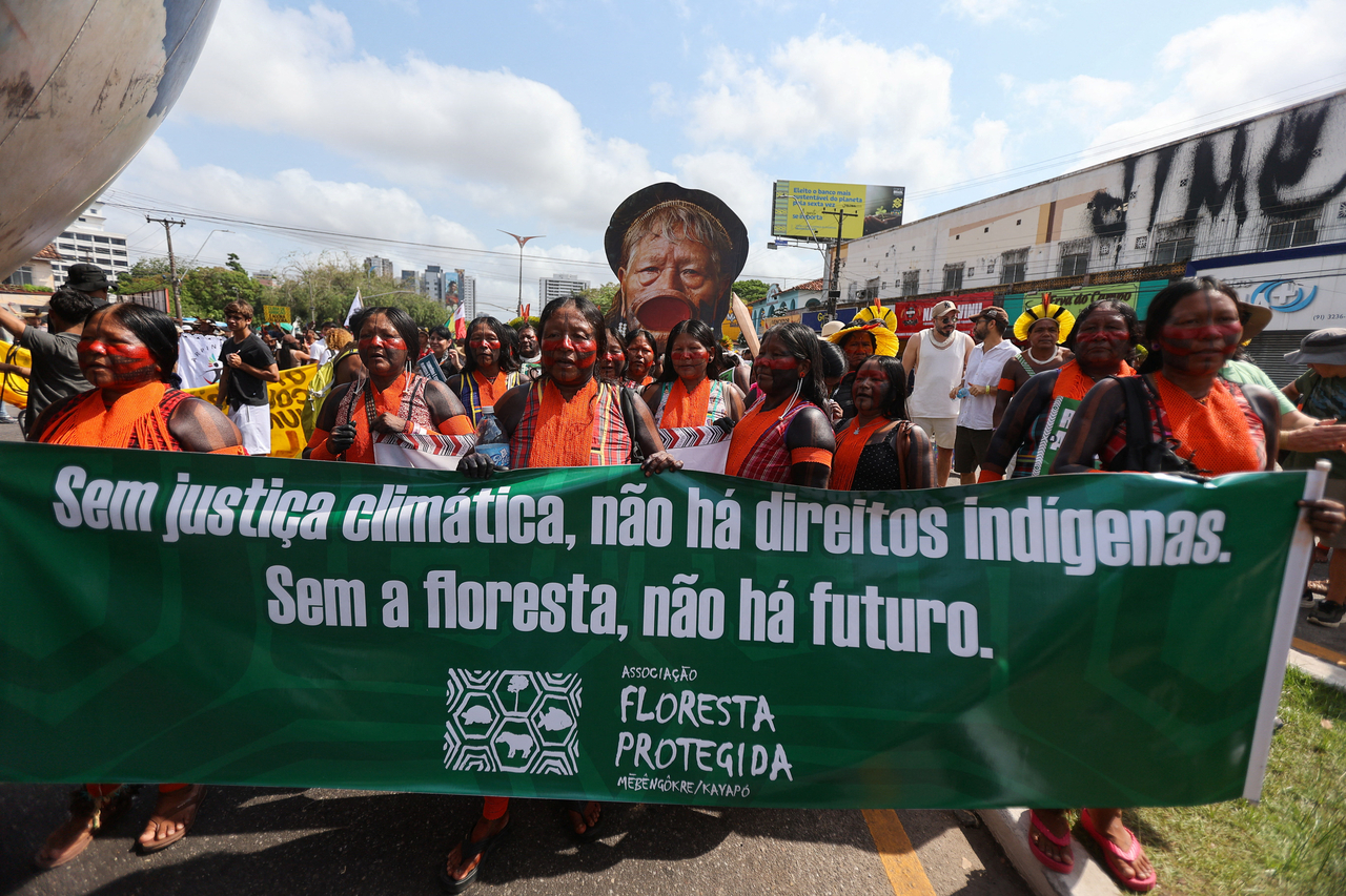 Demonstrators hold a banner that reads "Without climate justice, there are no indigenous rights. Without the forest, there is no future" during a protest in Belem, Brazil, Saturday. (Reuters-Yonhap)