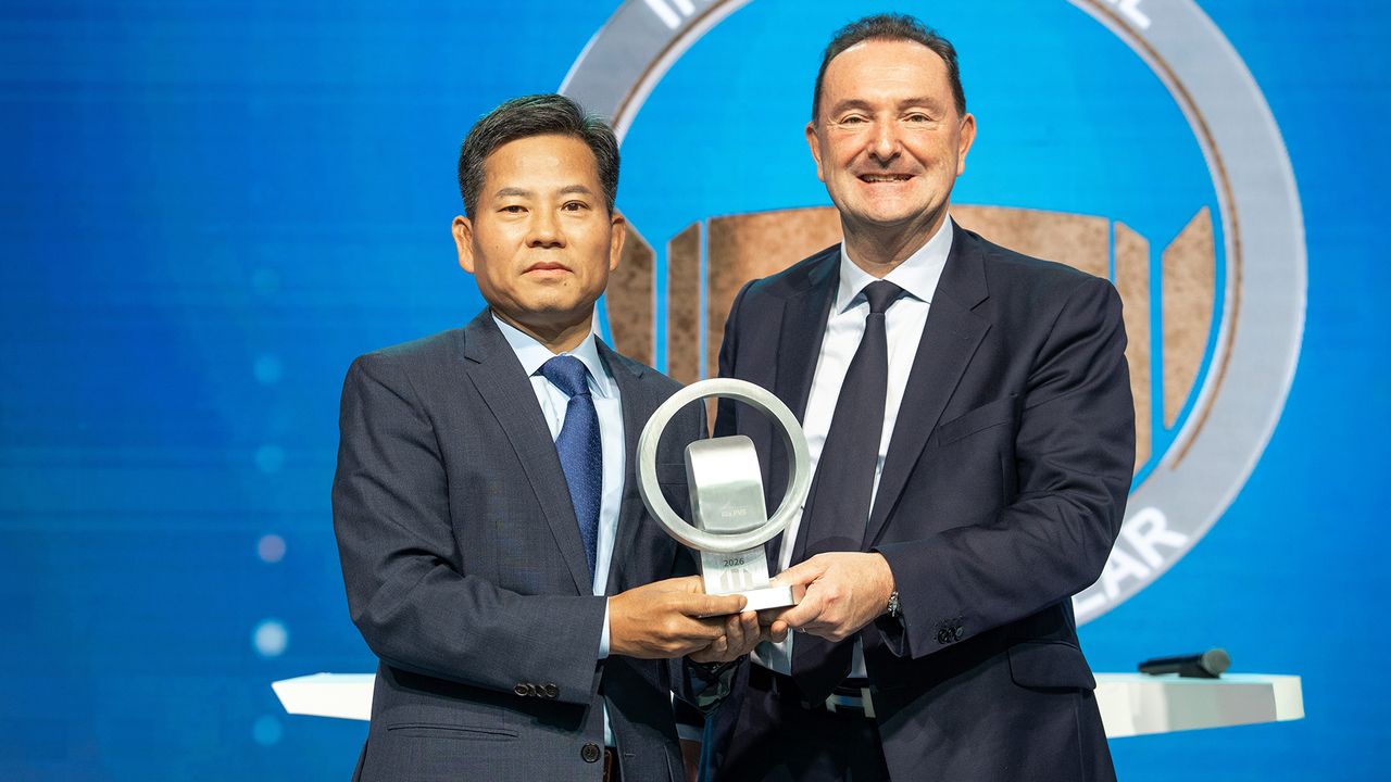 Kim Sang-dae (left), vice president of Kia's purpose-built vehicle division, and Marc Hedrich, head of Kia's European regional division, pose for a photo at the Solutrans 2025 global commercial vehicle trade fair in Lyon, France, Wednesday. (Hyundai Motor Group)