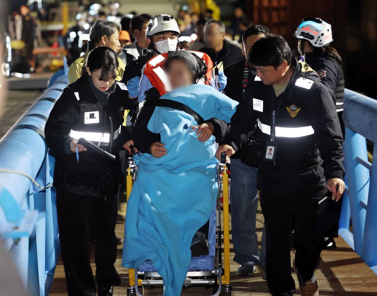 Passengers aboard the Queen Jenuvia II, which ran aground near Sinan County, South Jeolla Province, are rescued by authorities late Wednesday. (Yonhap)