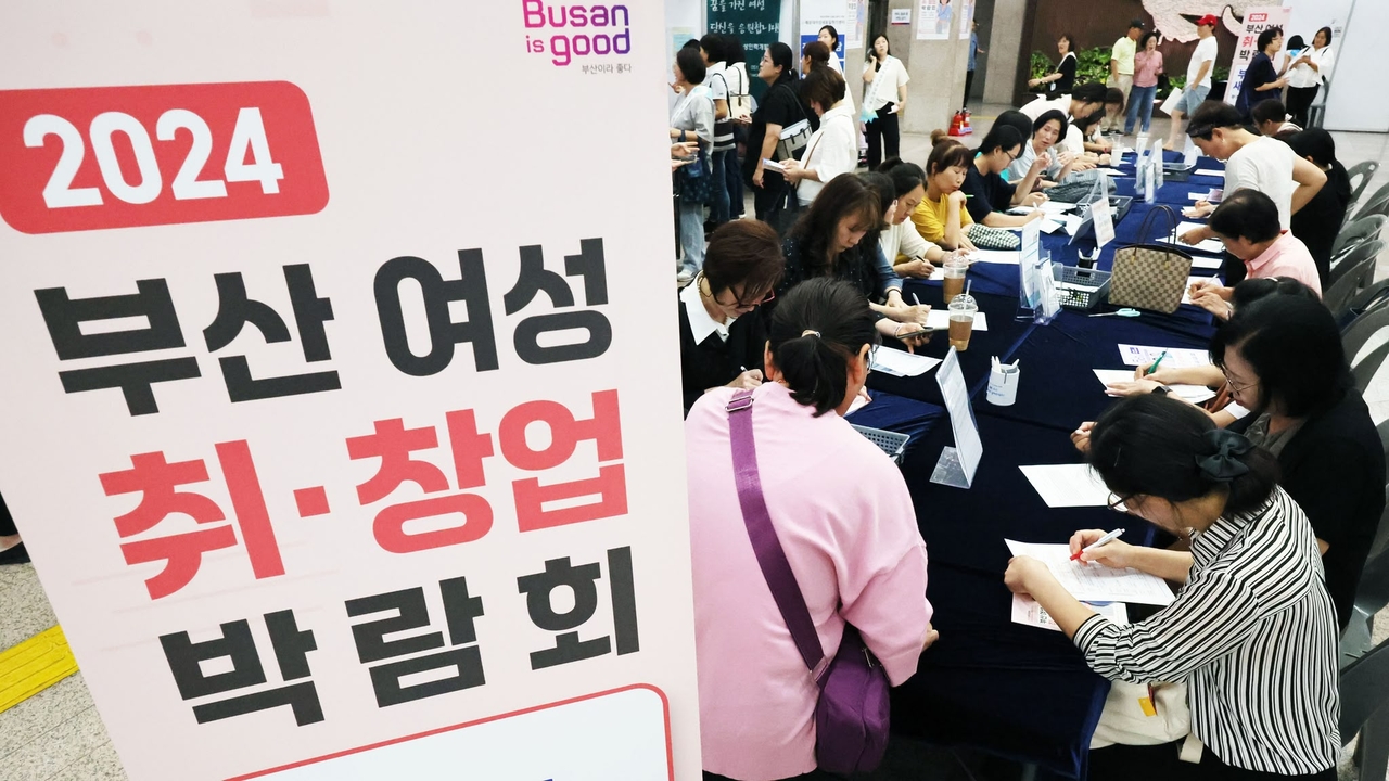 Applicants fill out forms at the 2024 Busan Women’s Employment and Startup Fair in September last year, an event at Busan City Hall designed to support women returning to work and exploring new business ventures. (Busan City Government)