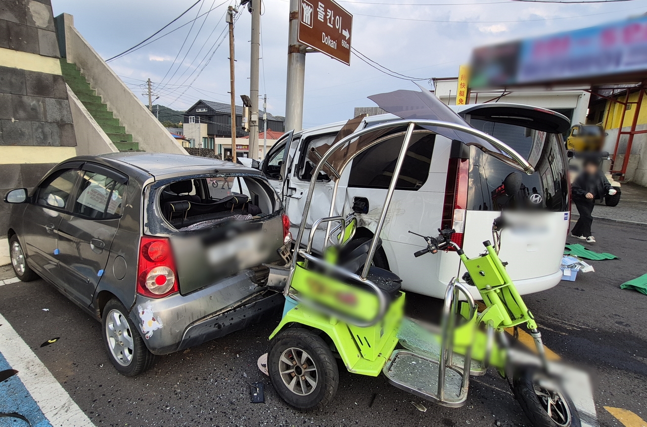 The white van that struck 10 tourists just outside a ferry terminal is seen crashed after hitting a road sign near Cheonjin Port on the small island of Udo, near Jeju Island, Monday. (Newsis)