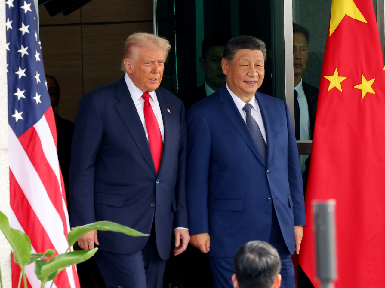 This photo shows US President Donald Trump (L) and Chinese President Xi Jinping shaking hands ahead of their summit talks in the southeastern city of Busan on Oct. 30. (Yonhap)