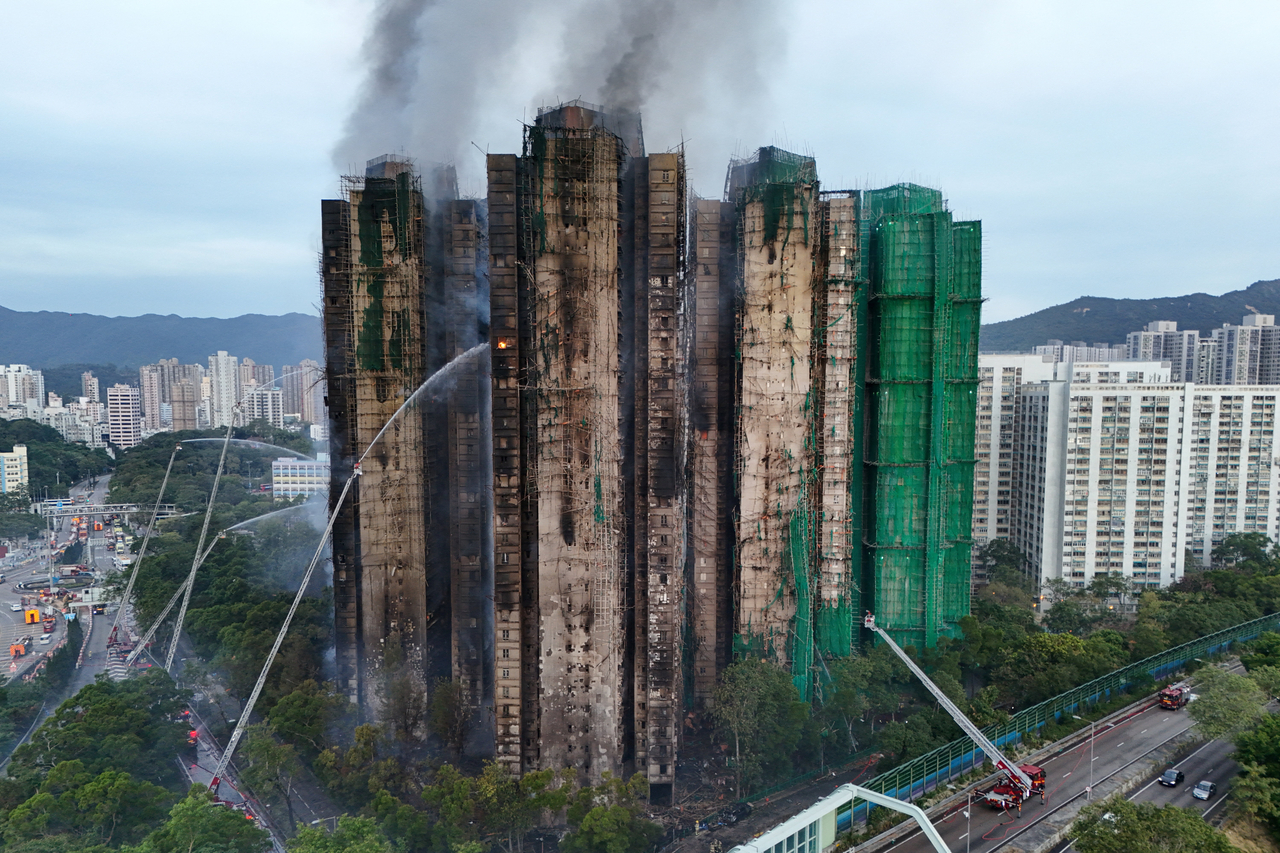 A drone view shows flames and thick smoke rising from the Wang Fuk Court housing estate during a major fire, in Tai Po, Hong Kong, China, Thursday. (Reuters -Yonhap)