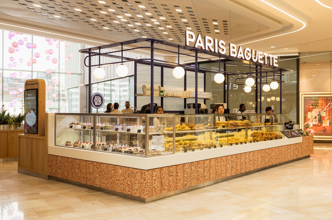 Paris Baguette flagship store at Westfield London with the chain's signature cerulean blue frames and marble counters, showcasing the Korean bakery cafe's global expansion.