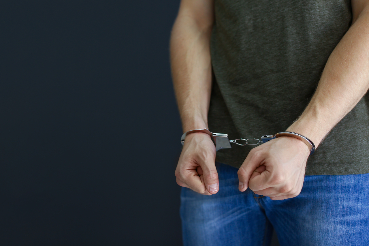 A stock photo of a handcuffed man (123rf)
