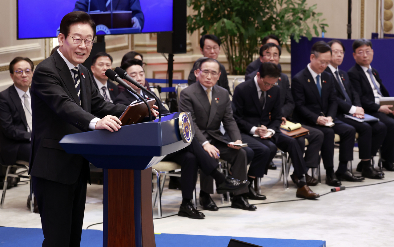 President Lee Jae Myung (left, front) is seen along with his aides during a news conference with foreign media held at the former presidential compound of Cheong Wa Dae in Seoul on Wednesday. (Pool photo via Yonhap)