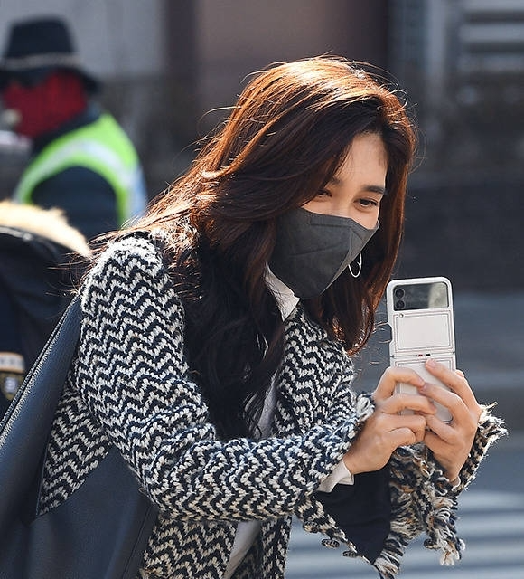 Hotel Shilla CEO Lee Boo Jin takes a photo of her son at his middle school graduation in February 2023. (Courtesy of Park Sun-young)
