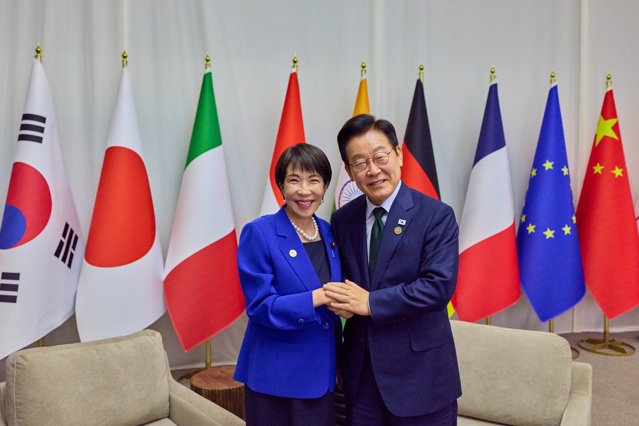 President Lee Jae Myung (right) poses with Japanese Prime Minister Sanae Takaichi ahead of their meeting on the sidelines of the Group of 20 leaders' summit in Johannesburg, South Africa, on Nov. 24. (Yonhap)
