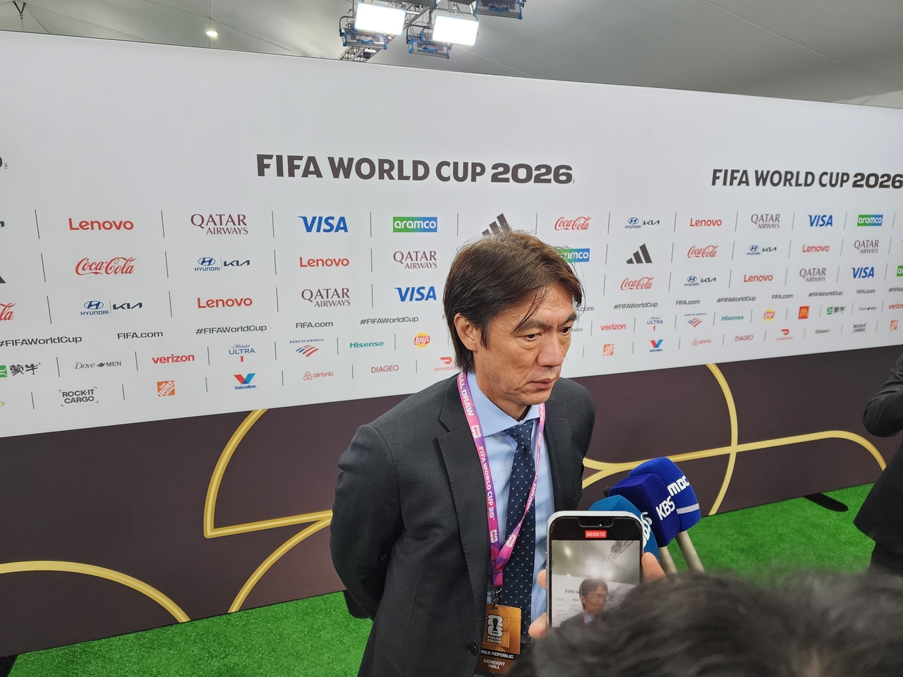 Hong Myung-bo, manager of the Korean men's national football team, speaks to reporters in the mixed zone after the draw ceremony for the 2026 FIFA World Cup in North and Central America, in Washington, D.C., Friday. (Yonhap)