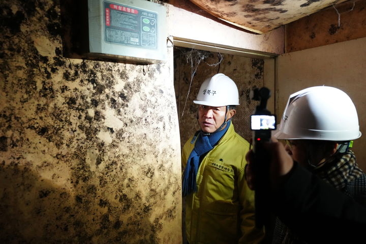 Lee Seung-ro, mayor of Seongbuk-gu, looks inside a demolished brothel in Miari Texas on Nov.24. (Seongbuk District Office)