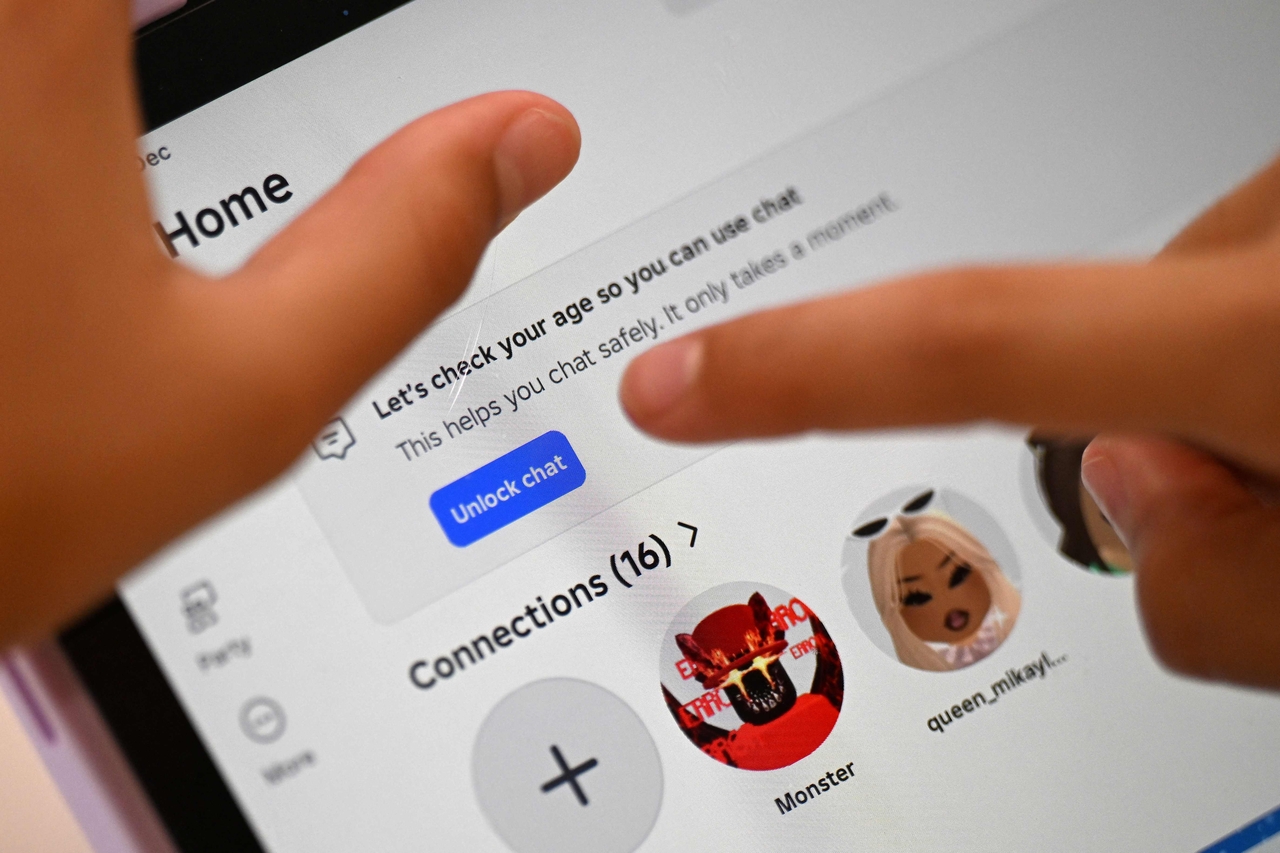 A young teenager tries to unlock a social media site after receiving an age verification message at her home in western Sydney on Wednesday.   AFP-Yonhap