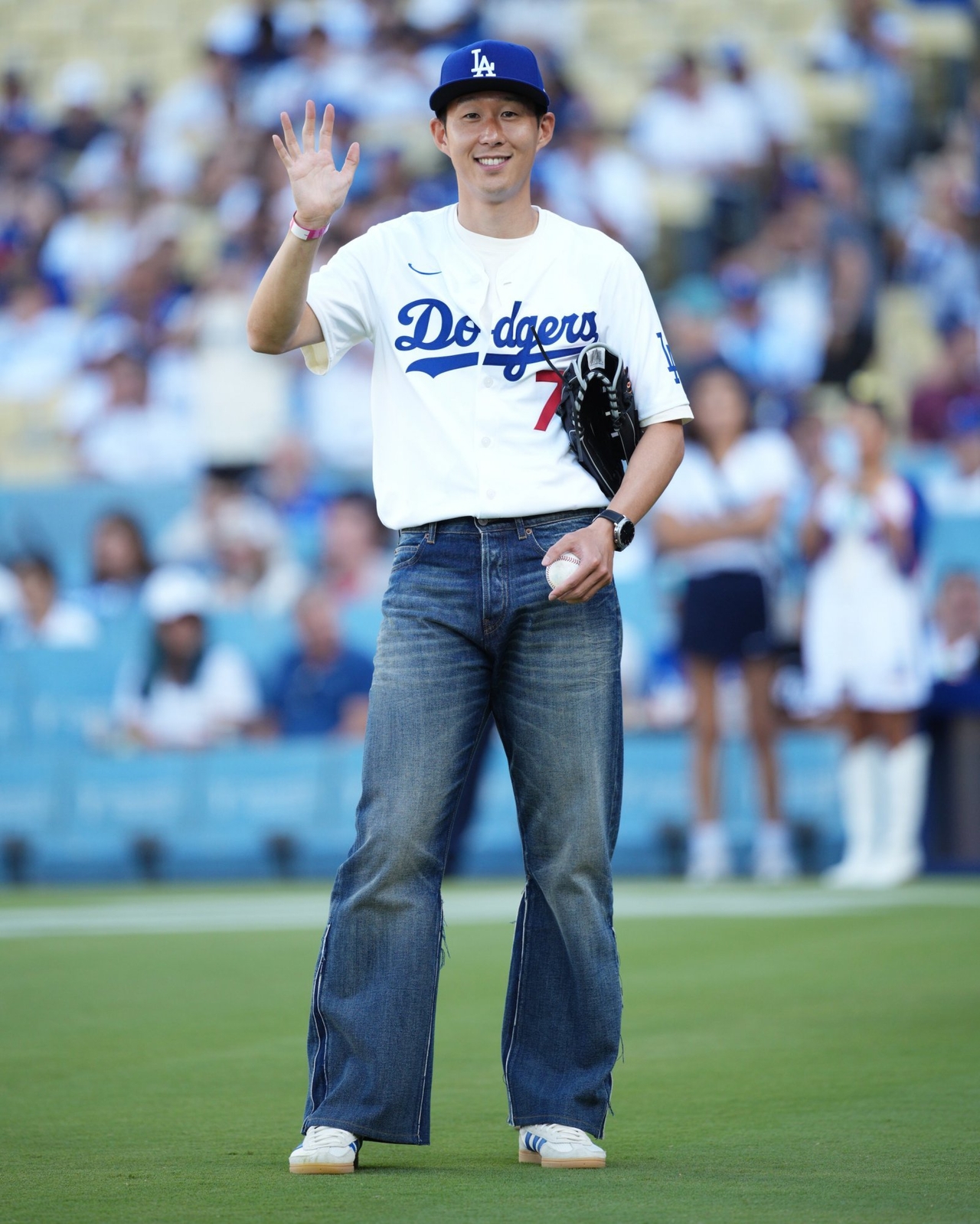 Soccer player Son Heung-min throws the first pitch at a night game