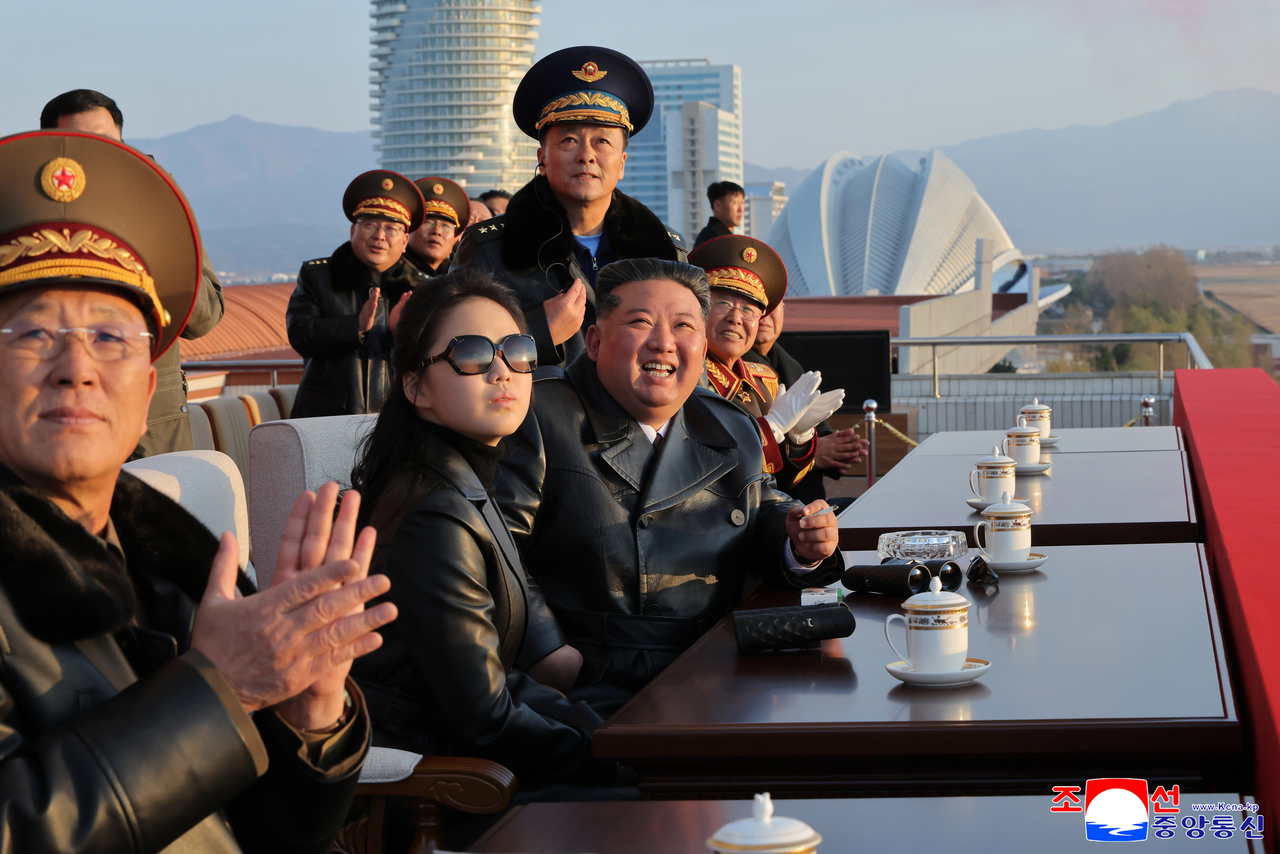 North Korean leader Kim Jong-un (center) accompanied by his daughter Ju-ae, attends an event marking the 80th anniversary of the country’s Air Force at the Galma airfield in the 59th Kim Young-jo Hero Regiment of the 2nd Air Division on Nov. 28, praising the troops and watching an air show, commemorative rally and performance, KCNA reported on Nov. 30. (Photo not directly related to the article)  (KCNA-Yonhap)