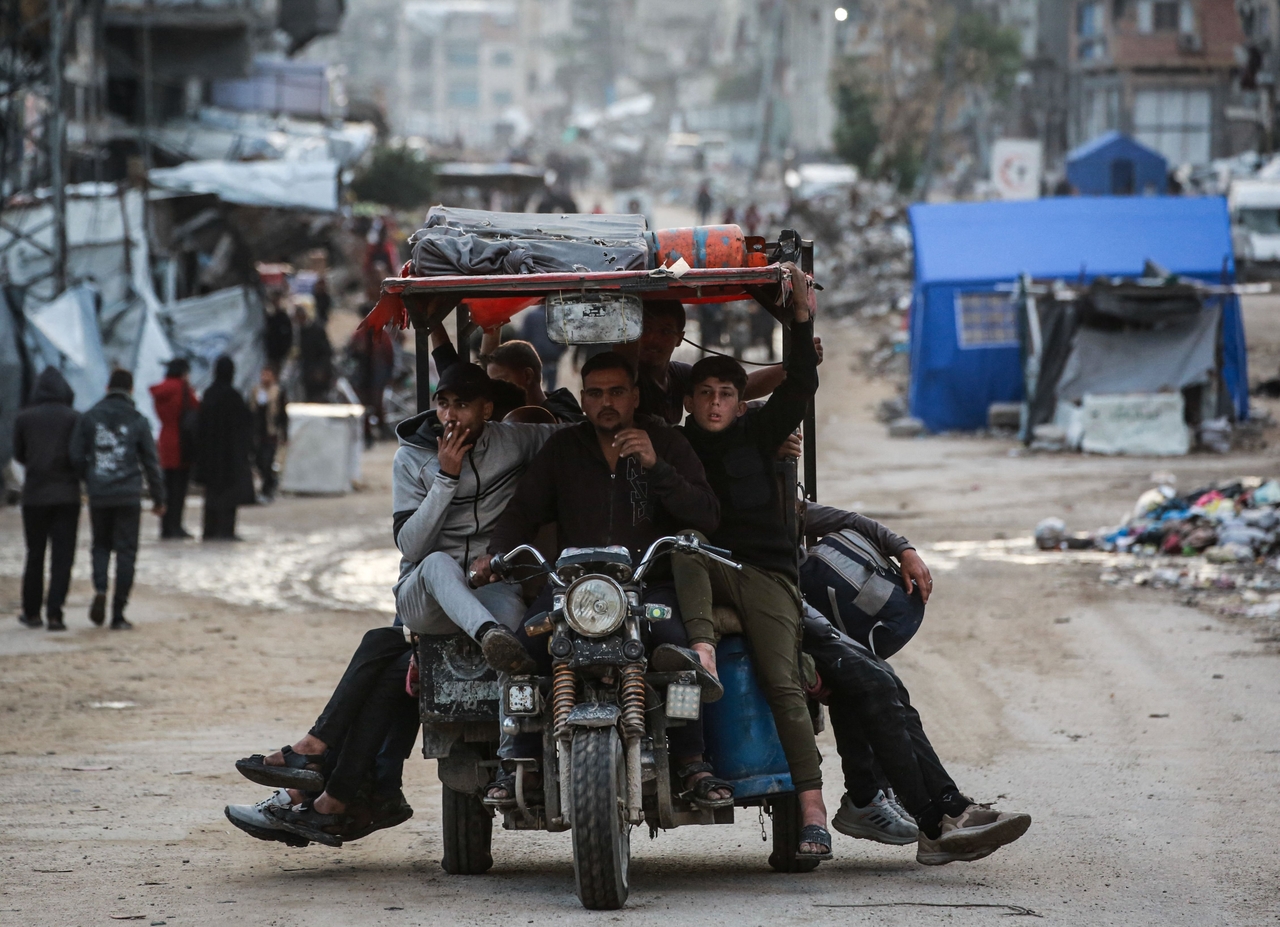 Men drive down the road in the Al-Saftawi neighborhood, west of Jabalia city in the northern Gaza Strip, Wednesday. (AFP-Yonhap)
