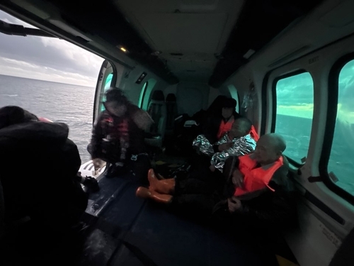 Crew members are rescued after falling overboard from a merchant ship sailing off the southwest coast of Seogwipo on Jeju Island, Friday. (Seoguipo Coast Guard)