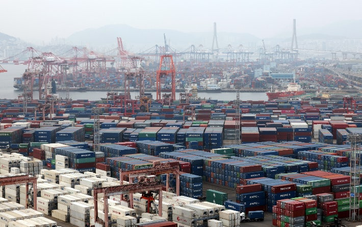 Shipping containers are stacked at Busan North Port in Busan. (Yonhap)