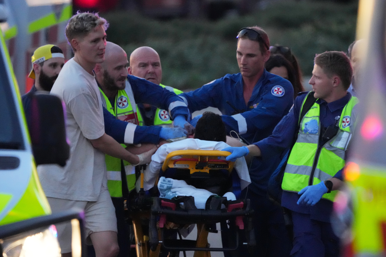 Emergency workers transport a person on a stretcher after a reported shooting at Bondi Beach, in Sydney, Sunday. (AP-Yonhap)