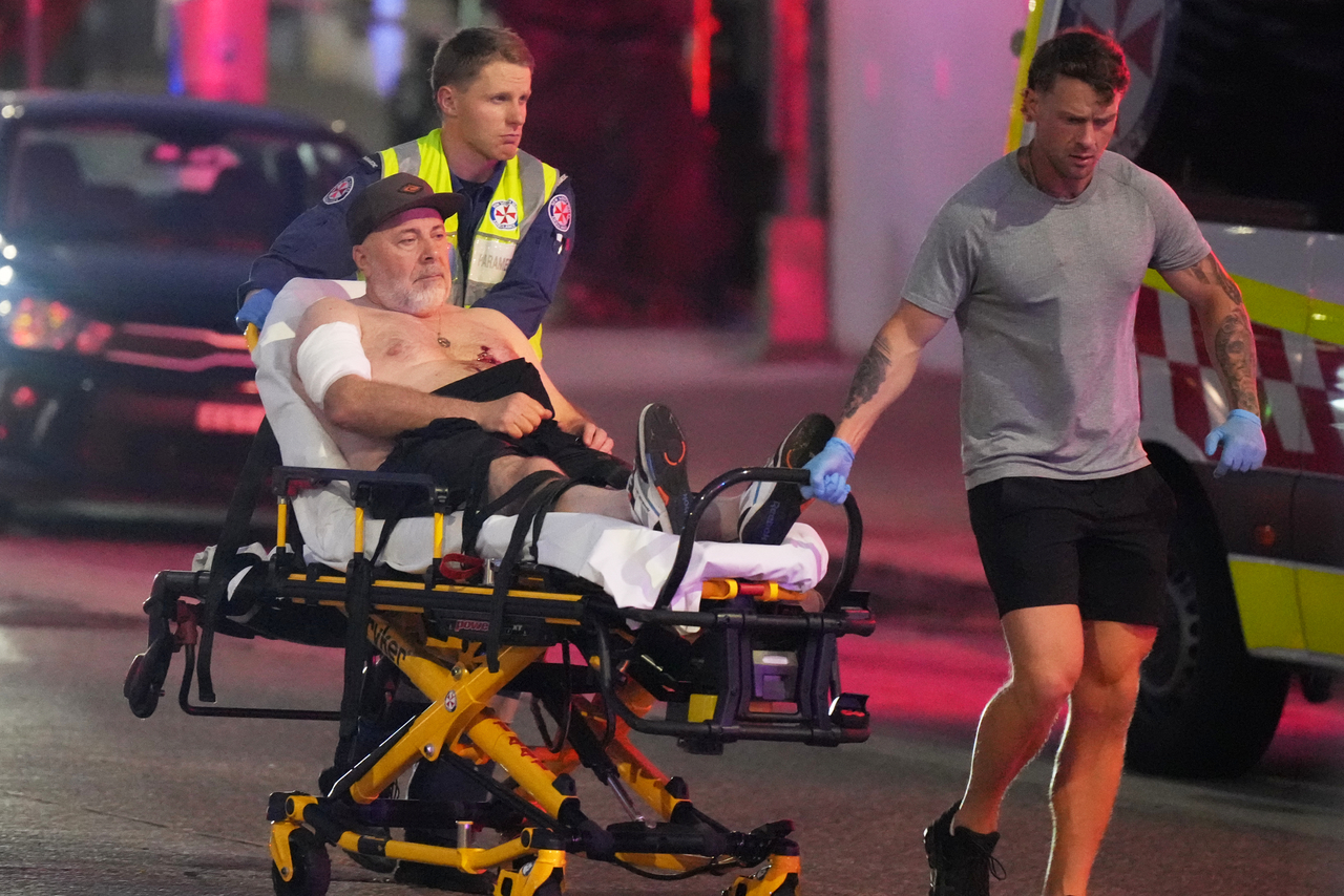 Emergency workers transport a person on a stretcher after a reported shooting at Bondi Beach in Sydney, Sunday. (AP-Yonhap)