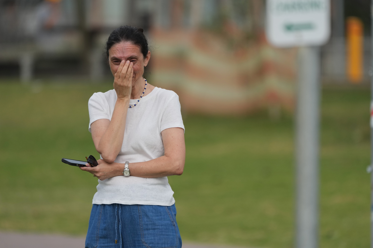 A woman reacts a day after a shooting at Sydney's Bondi Beach, Monday. (AP-Yonhap)