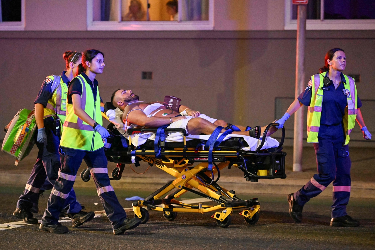 Emergency workers transport a person on a stretcher after a reported shooting at Bondi Beach in Sydney, Sunday. (AP-Yonhap)