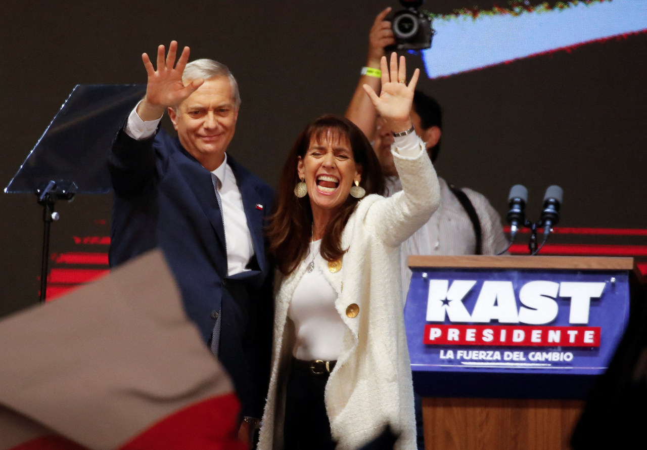 Jose Antonio Kast, presidential candidate of the Republican Party of Chile, and his wife Maria Pia Adriasola wave to their supporters in Santiago, Chile, Sunday. (Reuters-Yonhap)